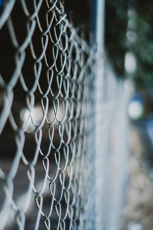 Vertical shot wired fence with blurred background